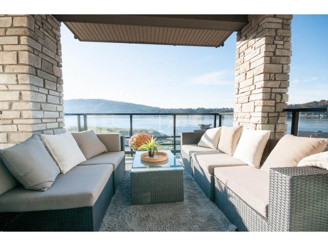 Furnished living room with a view of the water and mountains. - 203 - 3825 Cate's Landing, North Vancouver