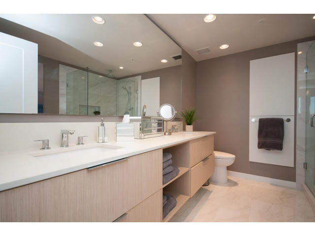 Spacious bathroom with dual sinks, modern fixtures, and a walk-in shower. - 203 - 3825 Cate's Landing, North Vancouver