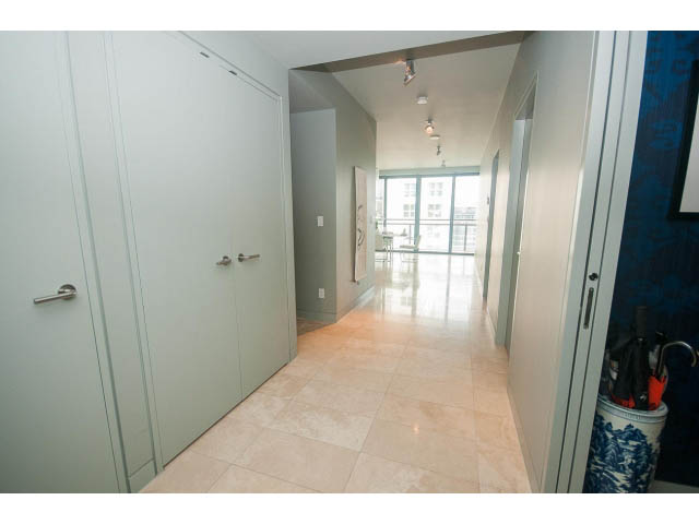 Furnished hallway leading to a bright living area with city view. - 2301 - 838 W Hastings, Vancouver Downtown