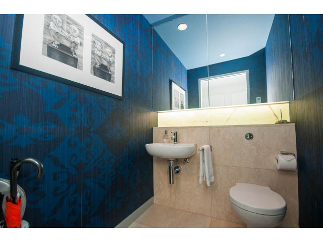 Furnished bathroom with blue patterned walls, modern sink, and large mirror. - 2301 - 838 W Hastings, Vancouver Downtown