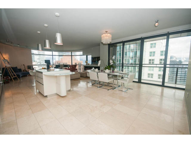 Spacious living room with large windows, city view, and modern furnishings. - 2301 - 838 W Hastings, Vancouver Downtown