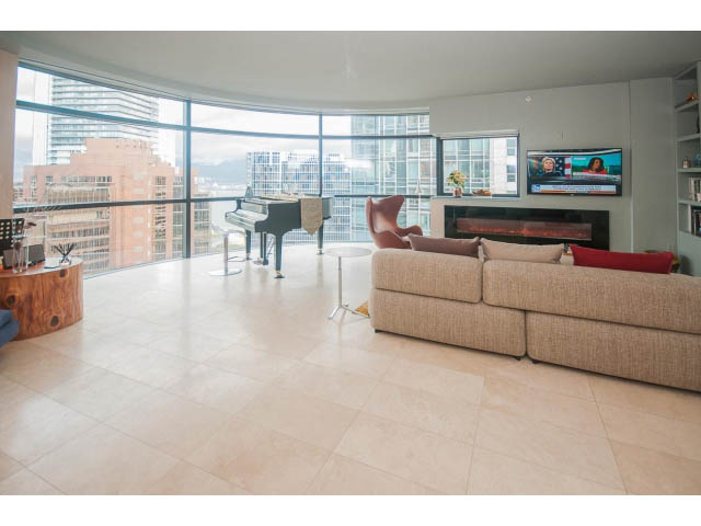 Furnished living room with city view, piano, and modern fireplace. - 2301 - 838 W Hastings, Vancouver Downtown