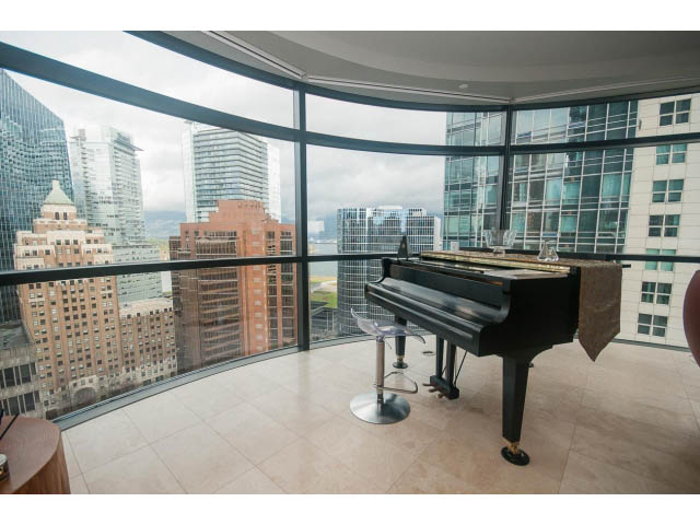 Bright living room with panoramic city view and modern furniture. - 2301 - 838 W Hastings, Vancouver Downtown