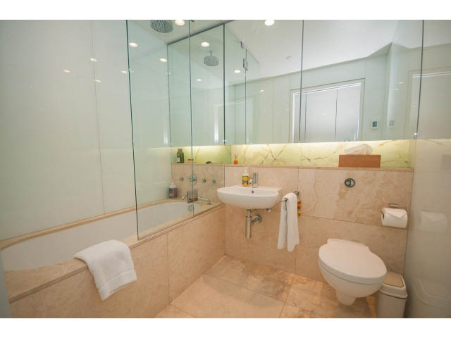 Spacious bathroom with marble countertops and a large glass shower. - 2301 - 838 W Hastings, Vancouver Downtown