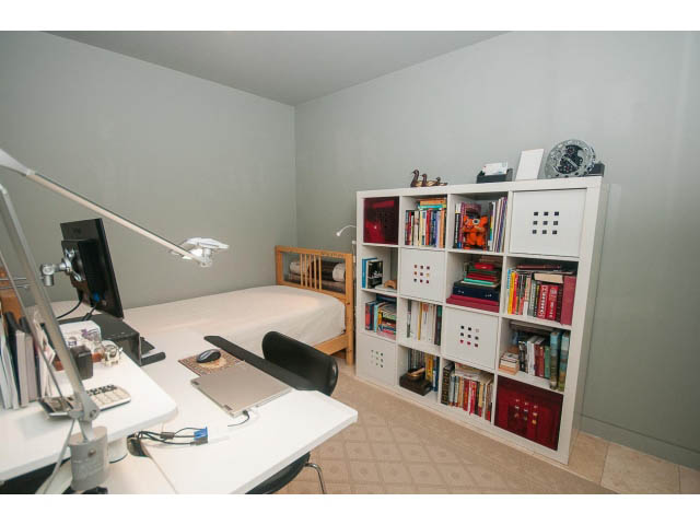 Bright and organized office space with white shelves, books, and a desk lamp. - 2301 - 838 W Hastings, Vancouver Downtown