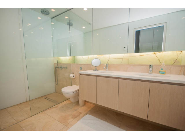 Furnished bathroom with wooden cabinets and marble countertop. - 2301 - 838 W Hastings, Vancouver Downtown