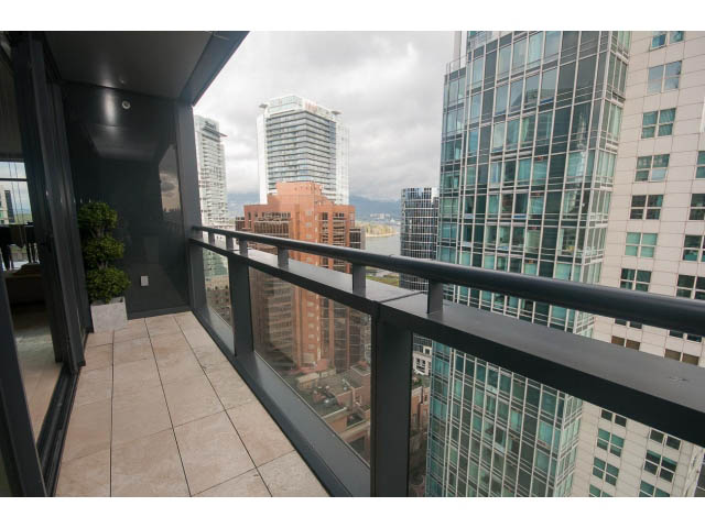 Furnished balcony with city view and modern glass facade. - 2301 - 838 W Hastings, Vancouver Downtown