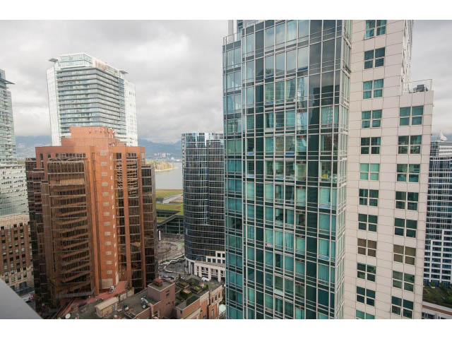Bright living room with city view and modern furnishings. - 2301 - 838 W Hastings, Vancouver Downtown