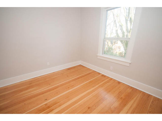 Bright bedroom with hardwood floors and a large window. - 516 E 10th Ave, Vancouver East Side