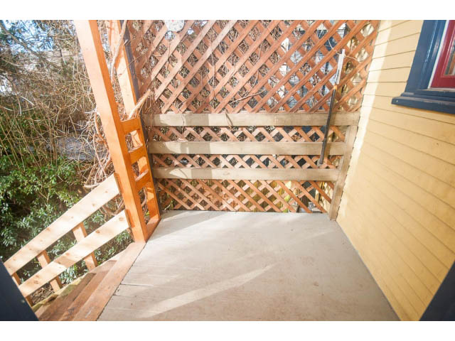 Outdoor deck with wooden lattice and steps leading up to a house. - 516 E 10th Ave, Vancouver East Side