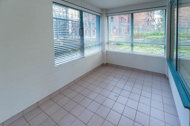 Bright sunroom with tiled floor, large windows, and city view. - 204 - 283 Davie Street, Vancouver Downtown