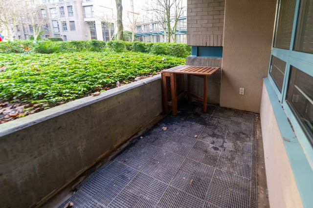 Furnished balcony with wooden table and greenery, city view. - 204 - 283 Davie Street, Vancouver Downtown