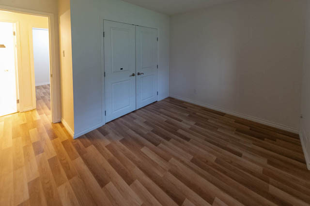 Bright den with hardwood floors and white walls, leading to another room. - 204 - 283 Davie Street, Vancouver Downtown