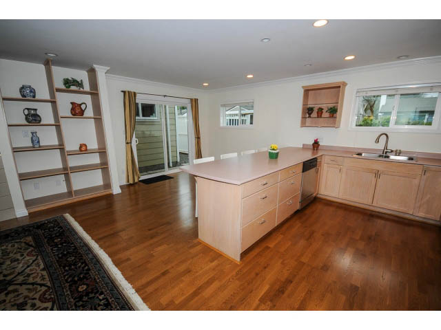 Bright kitchen with light wood cabinets, hardwood floors, and a city view. - 1397 Tatlow Avenue, North Vancouver