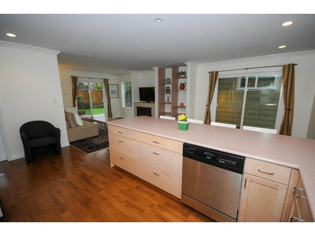 Bright kitchen with light wood cabinets and stainless steel appliances, hardwood floors. - 1397 Tatlow Avenue, North Vancouver
