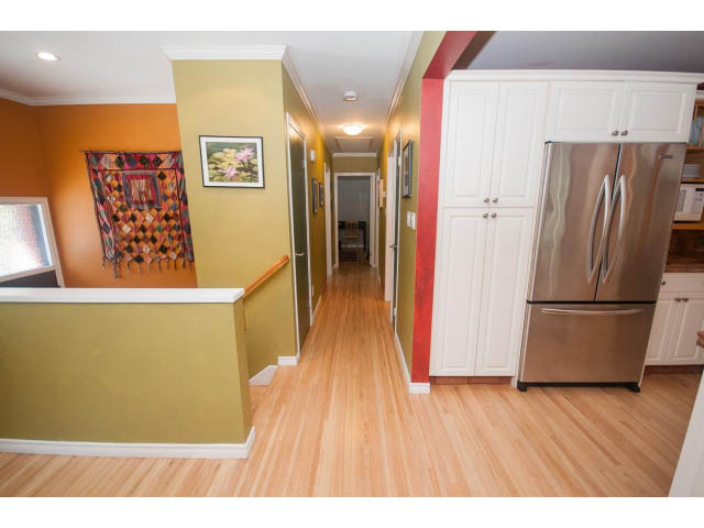 Bright kitchen with stainless steel appliances and hardwood floors. - 2972 Wembley Dr, North Vancouver