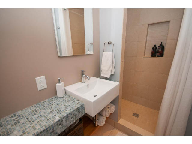 Modern bathroom with mosaic countertop and built-in storage. - 2972 Wembley Dr, North Vancouver