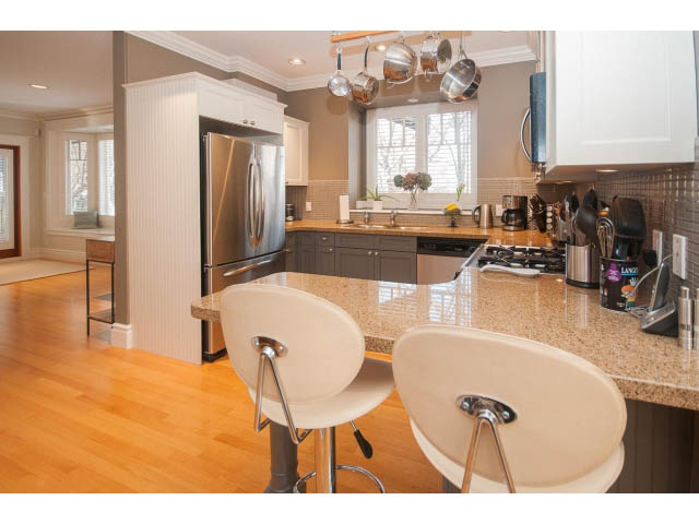 Bright kitchen with granite countertops, hardwood floors, and stainless steel appliances. - 398 W 13th Ave, Vancouver West Side