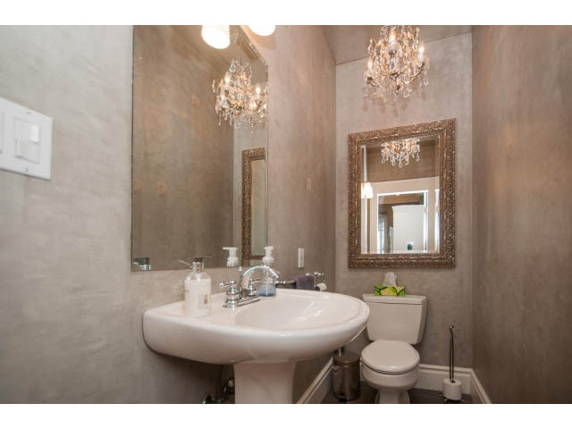 Furnished bathroom with elegant mirrors and chandelier, beige walls. - 398 W 13th Ave, Vancouver West Side