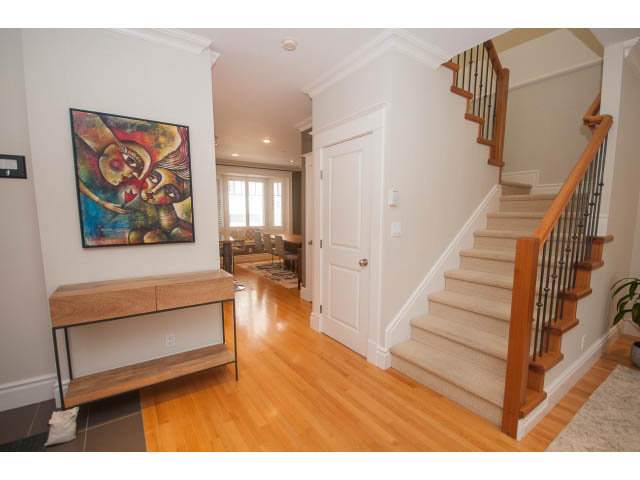 Furnished entryway with hardwood floors, staircase, and colorful artwork. - 398 W 13th Ave, Vancouver West Side