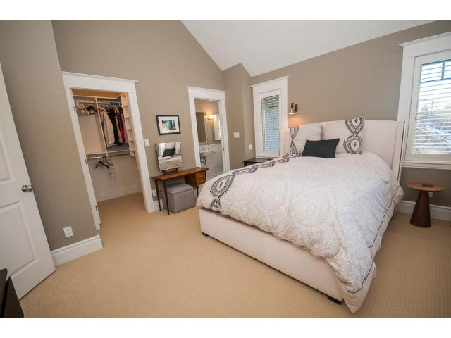 Spacious bedroom with large closet, patterned bedding, and natural light from windows. - 398 W 13th Ave, Vancouver West Side