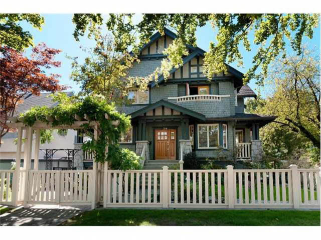 Furnished 2-bedroom + den triplex with wooden exterior, white picket fence, and lush greenery. - 398 W 13th Ave, Vancouver West Side