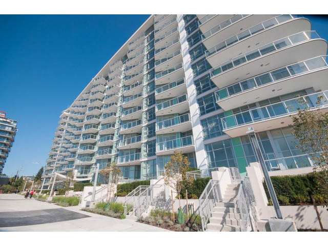Bright and airy 1-bedroom + den condo with large windows and modern balcony railings. - 1008-199 Victory Ship Way, North Vancouver