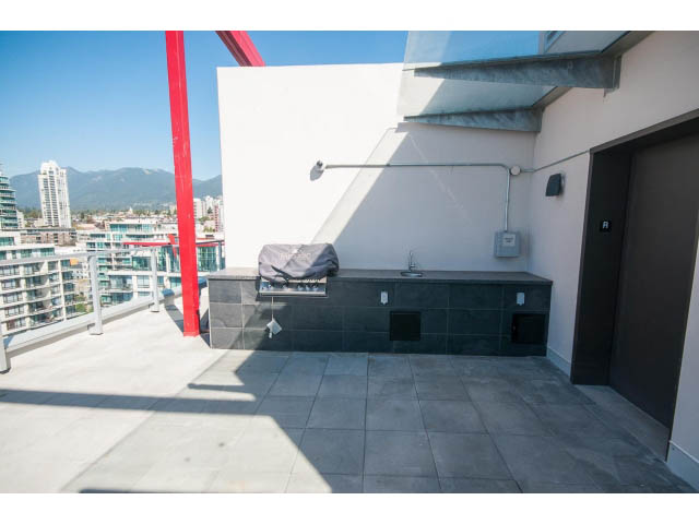 Furnished rooftop patio with city view and outdoor grill. - 1008-199 Victory Ship Way, North Vancouver