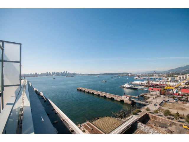 Bright balcony with stunning city and water views, featuring a modern balcony railing. - 1008-199 Victory Ship Way, North Vancouver