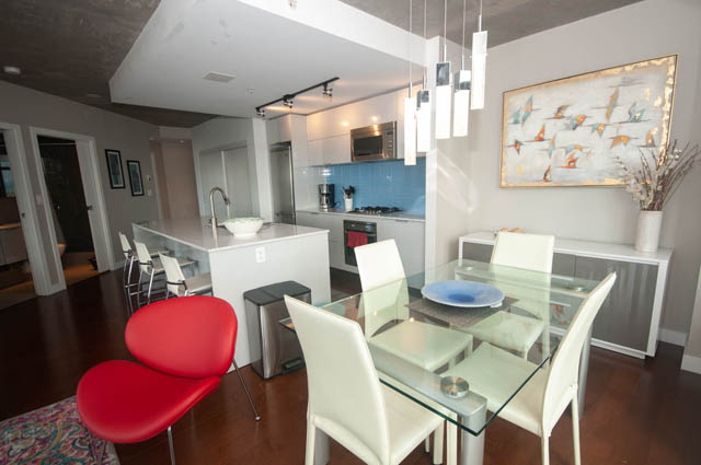 Bright kitchen with white countertops and hardwood floors, modern decor, and a city view. - 3806 - 128 Cordova St W, Vancouver Downtown
