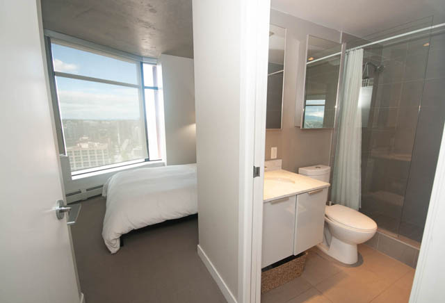 Spacious bathroom with large window, city view, and modern fixtures. - 3806 - 128 Cordova St W, Vancouver Downtown