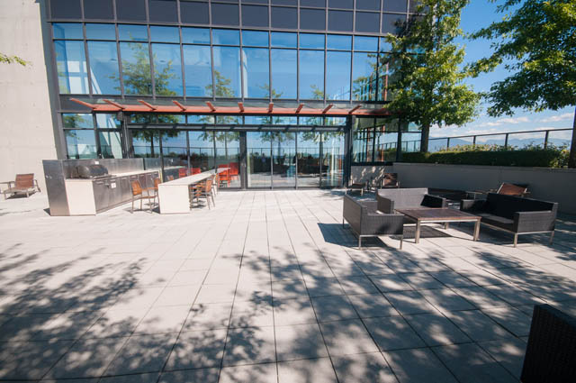 Furnished patio with outdoor seating and modern glass facade. - 3806 - 128 Cordova St W, Vancouver Downtown