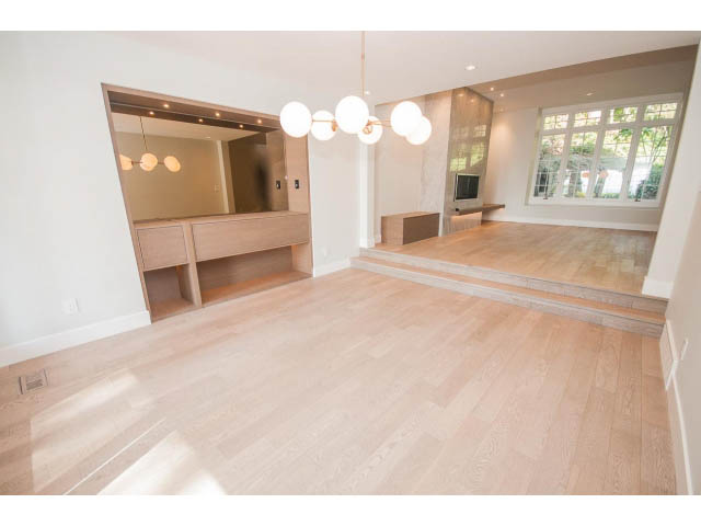 Bright living room with hardwood floors and modern chandelier. - 6018 Gleneagles Place, West Vancouver