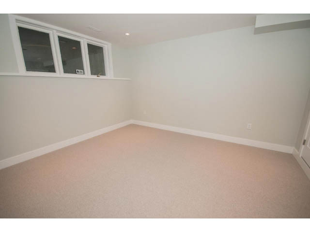 Bright bedroom with carpeted floor and small window. - 6018 Gleneagles Place, West Vancouver