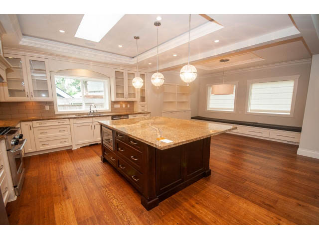 Bright kitchen with granite countertops, hardwood floors, and a city view. - 3476 Wellington Crescent, North Vancouver
