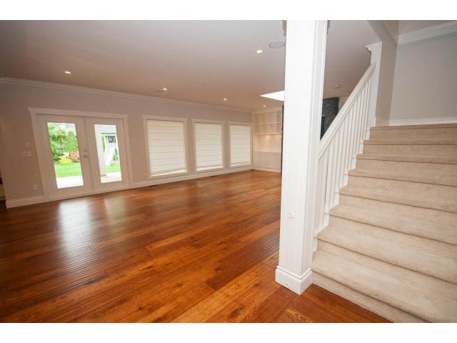 Bright living room with hardwood floors and a view of the backyard. - 3476 Wellington Crescent, North Vancouver