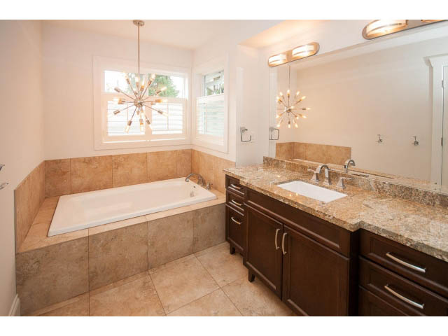 Spacious bathroom with granite countertops and a large soaking tub. - 3476 Wellington Crescent, North Vancouver