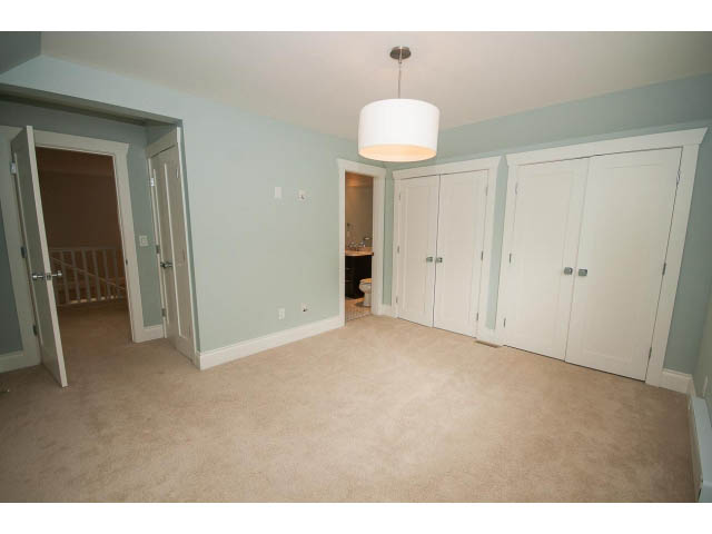 Spacious den with light walls, carpeted floor, and white cabinetry. - 3476 Wellington Crescent, North Vancouver