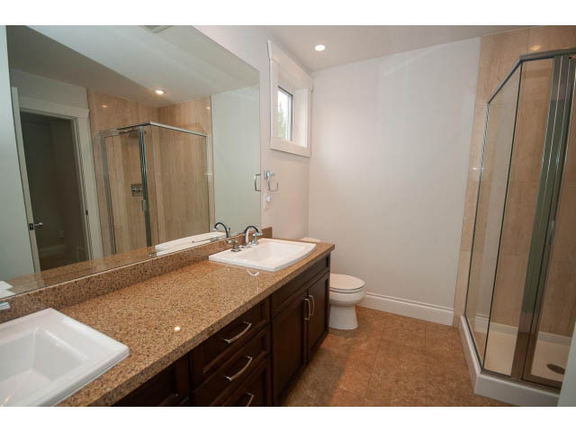 Furnished bathroom with granite countertops and a glass shower. - 3476 Wellington Crescent, North Vancouver