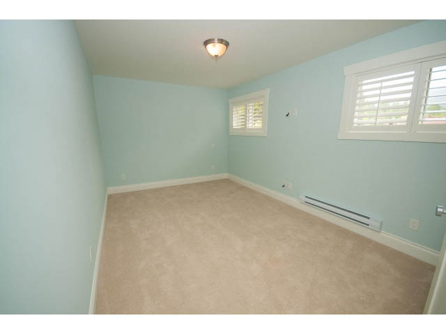 Spacious den with light blue walls, carpeted floor, and white shutters. - 3476 Wellington Crescent, North Vancouver
