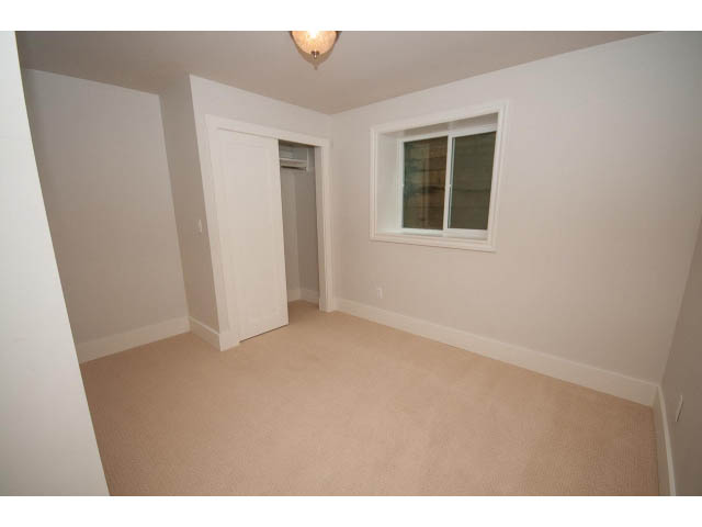 Spacious bedroom with carpeted floor and large window. - 3476 Wellington Crescent, North Vancouver
