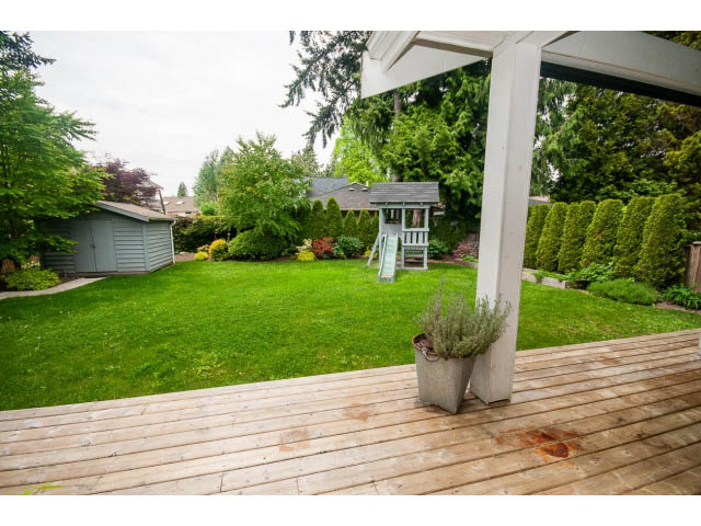 Bright deck with wooden flooring and a view of the garden and trees. - 3476 Wellington Crescent, North Vancouver