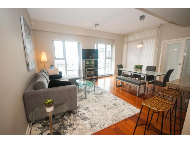 Spacious living room with hardwood floors, city view, and modern furnishings. - 3206 - 455 Beach Crescent, Vancouver Downtown