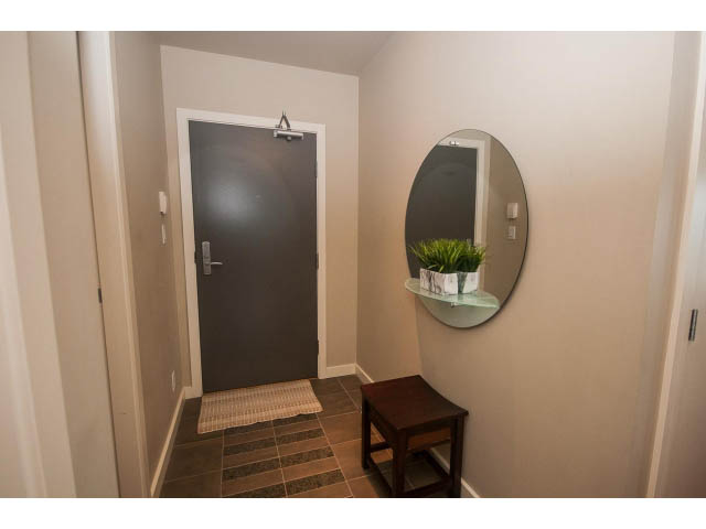 Furnished entryway with a round mirror, small table, and plant. - 3206 - 455 Beach Crescent, Vancouver Downtown