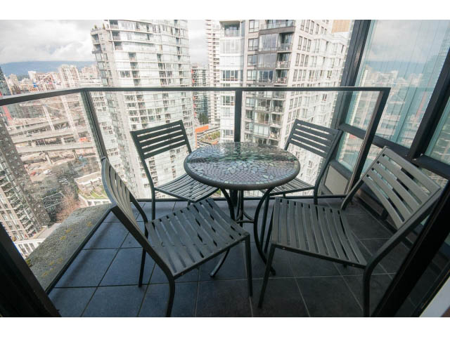 Furnished balcony with city view, modern furniture, and tiled floor. - 3206 - 455 Beach Crescent, Vancouver Downtown