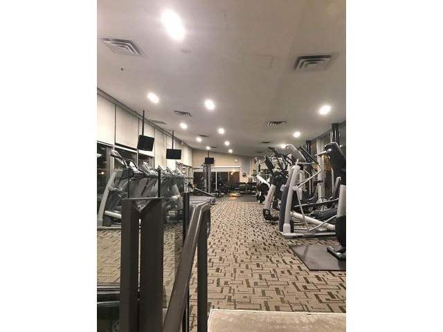 Furnished gym with cardio machines and weights, carpeted floor. - 3206 - 455 Beach Crescent, Vancouver Downtown