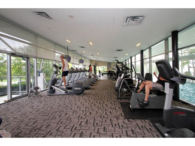 Bright fitness room with cardio machines and large windows, overlooking greenery. - 3206 - 455 Beach Crescent, Vancouver Downtown