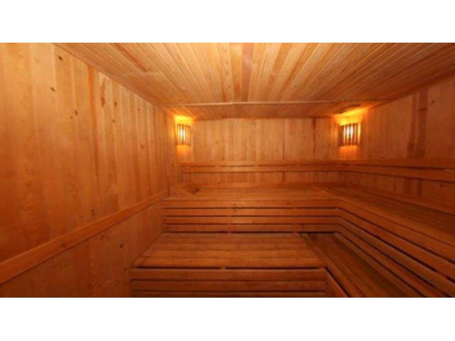 Spacious, cozy sauna with wooden benches and warm lighting. - 3206 - 455 Beach Crescent, Vancouver Downtown