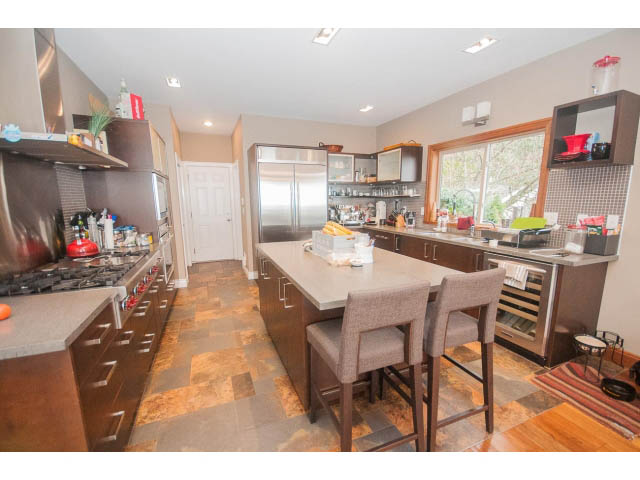 Bright kitchen with granite countertops, hardwood floors, and a city view. - Upper - 4407 Prospect Rd, North Vancouver