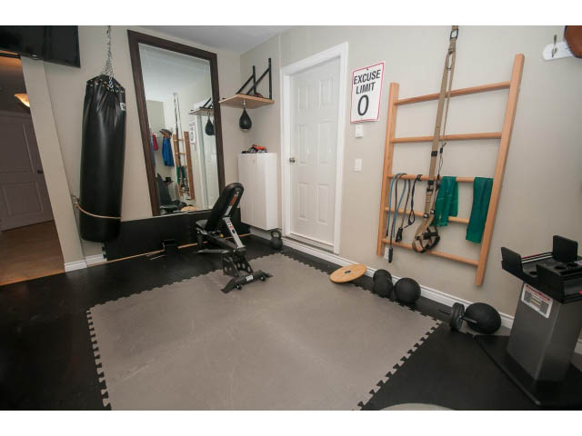 Fitness room with exercise equipment, punching bag, and Pilates bar. - Upper - 4407 Prospect Rd, North Vancouver
